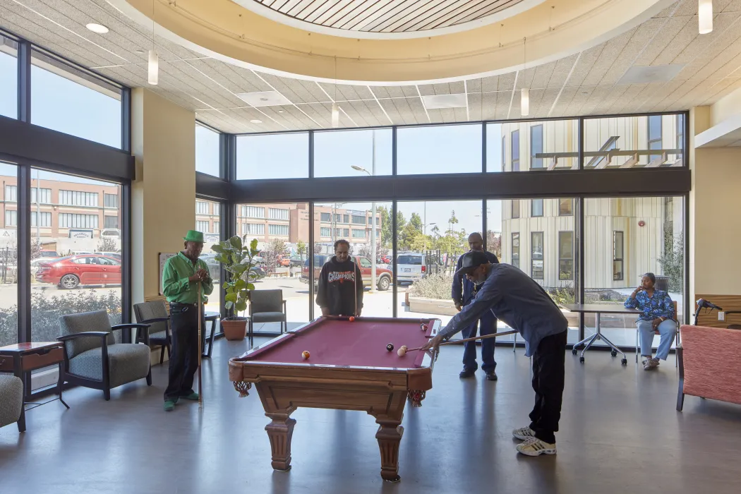 Residents playing pool at the Senior Center inside Dr. George Davis Senior Building in San Francisco.