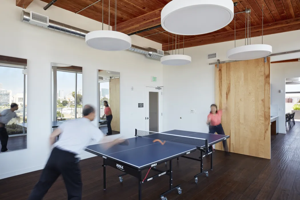 Residents playing table tennis in the wellness room in Lakeside Senior Housing in Oakland, Ca.