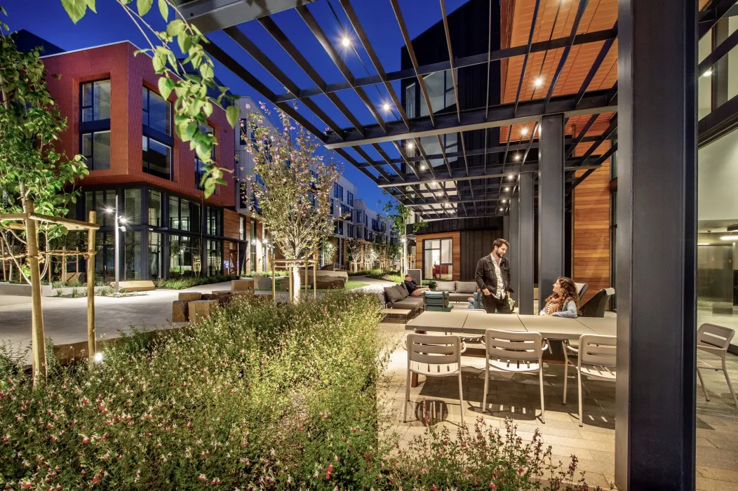 Exterior of leasing office with patio at dusk at Mason on Mariposa in San Francisco.