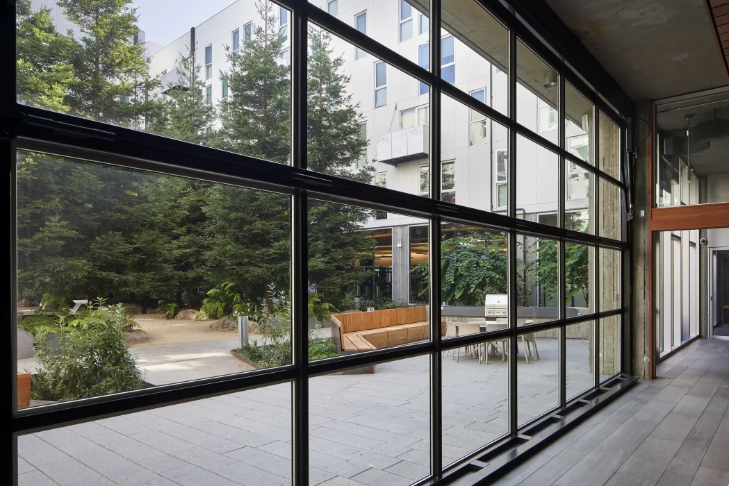 Looking out to the public open space from glass aircraft hanger door in 855 Brannan in San Francisco.