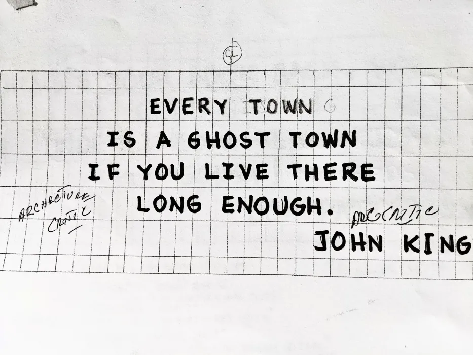 Sign for the previous 555 Larkin site that states "Every town is a ghost town if you live there long enough. - John King"