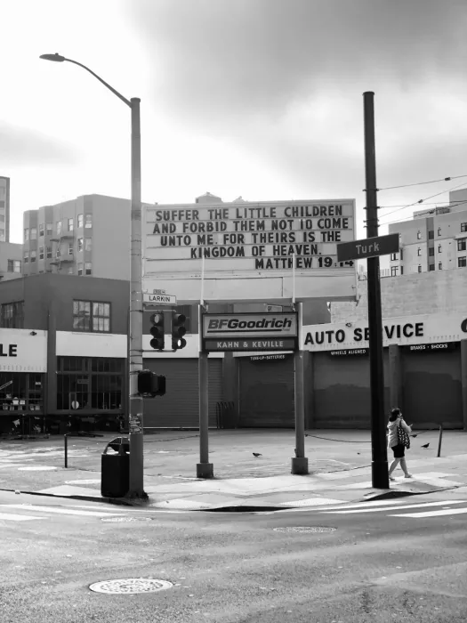 Sign at previous 555 Larkin site that states "Suffer the little children and forbid them not to come unto me for theirs is the kingdom of heaven. Matthew 19:14"