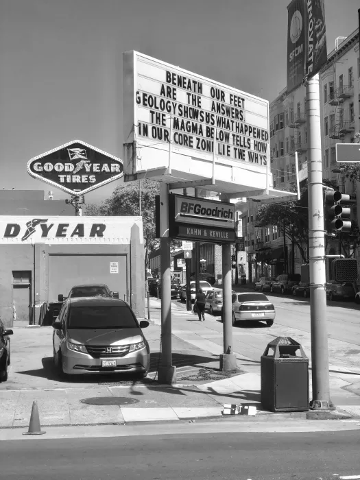 Sign at previous 555 Larkin site that states "Beneath our feet are the answers. Geology shows us what happened. The magma below tells how in our core zone lie the whys."