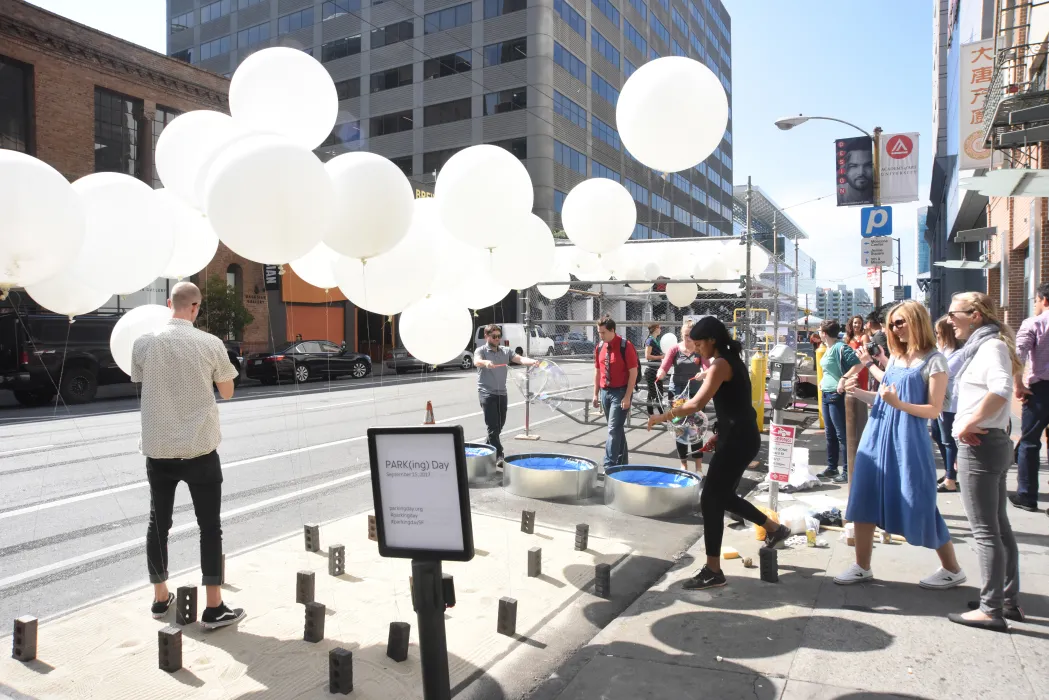 Firm next to Wishing Cloud had the same white balloons but staying in place with string.