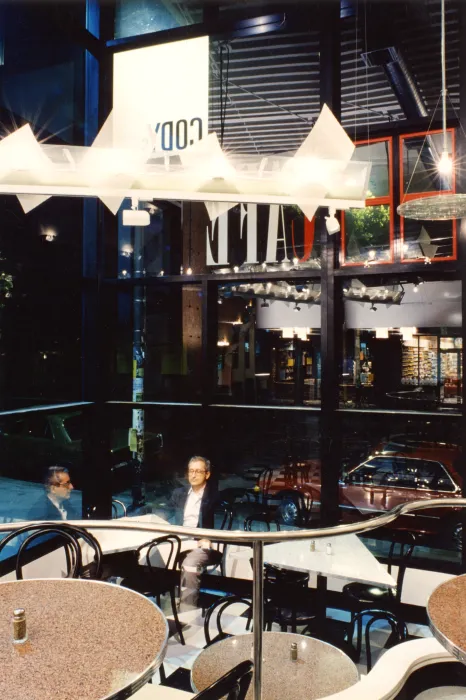 Seating area with hanging light fixtures inside  Fred Cody Building & Cody's Cafe in Berkeley, California.