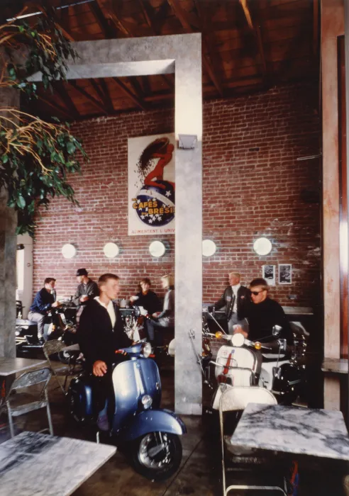 Interior view of Cafe Milano with customers sitting with their mopeds in Berkeley, California.