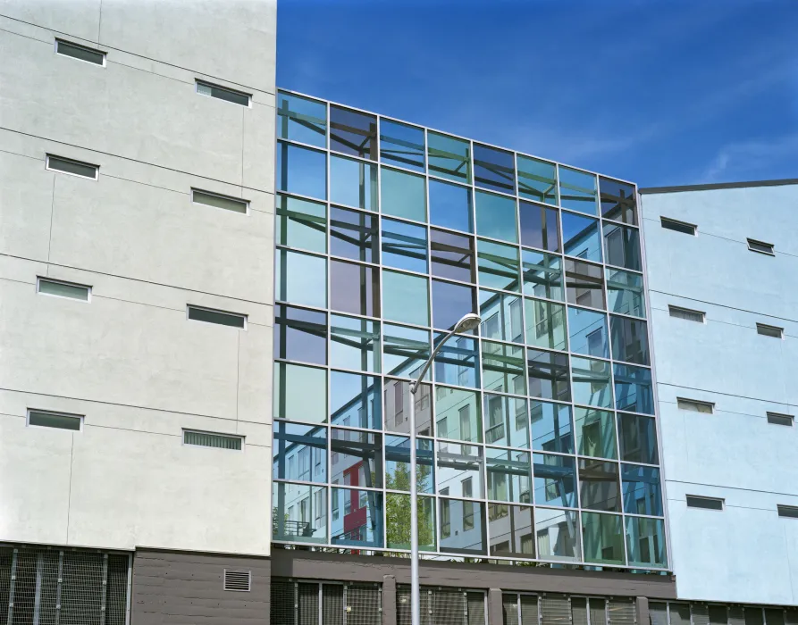 Exterior view of the glass sound wall at 888 Seventh Street in San Francisco.