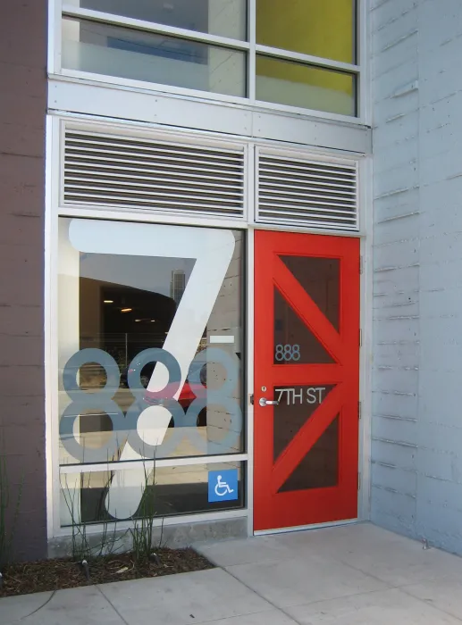 Entry signage and red K door at 888 Seventh Street in San Francisco.