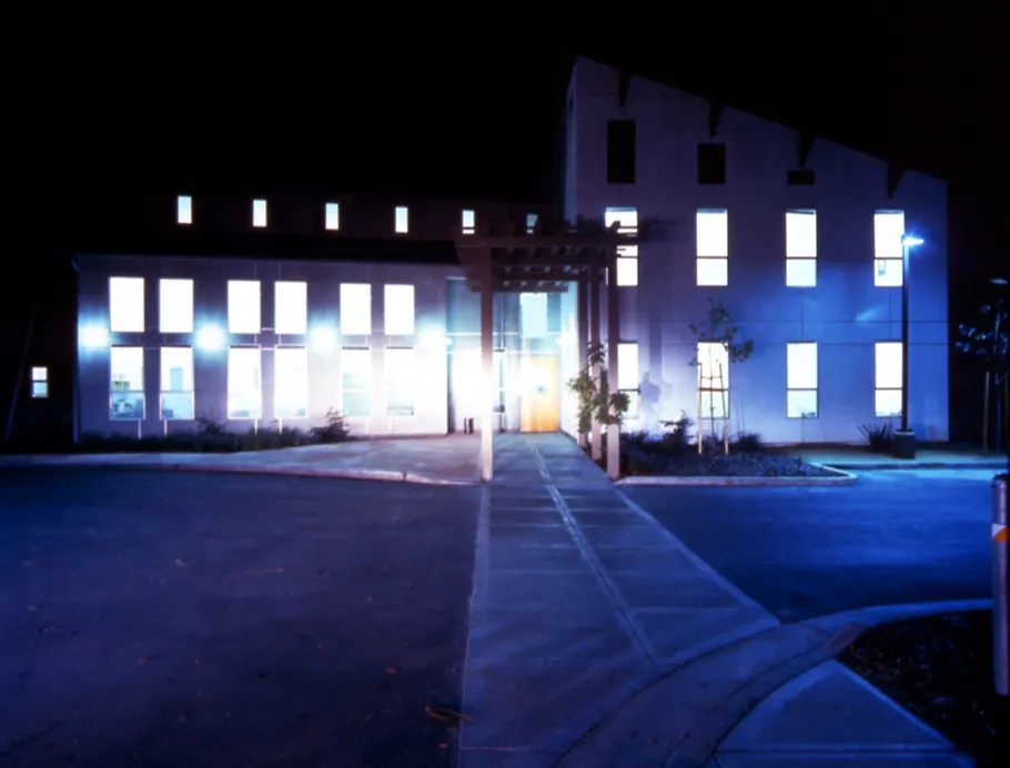 Exterior view of Sunrise Village at night with lights illuminated from the windows in Fremont, California.