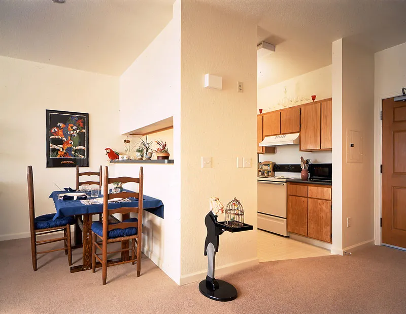 Interior view of dining room and kitchen unit at Plaza Maria in San Jose, California.