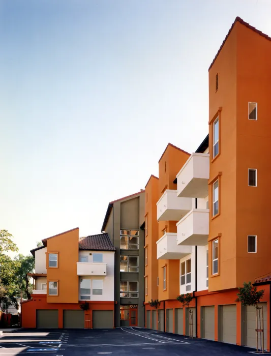 Exterior view of the units with tucked under garages at Plaza Maria in San Jose, California.