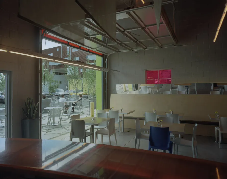 Cafe seating inside and spilling out the courtyard of Taxi 2 in Denver, Colorado. 