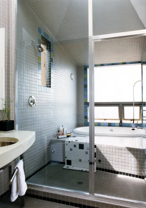 White tile shower and tub inside of Kayo House in Oakland, California.