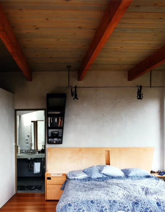 Bedroom with wood headboard inside Kayo House in Oakland, California.