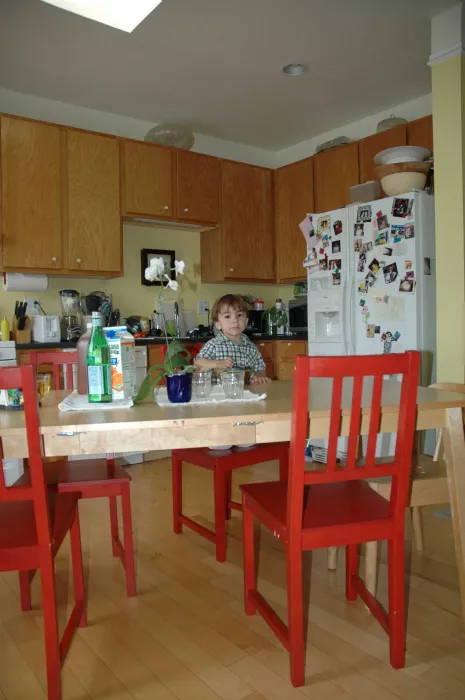 Toddler sits a his kitchen table inside a unit at Bell Mews in San Francisco. 