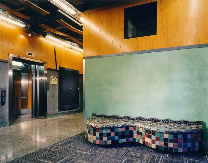 Interior view of the form lobby with a mosaic tile bench.