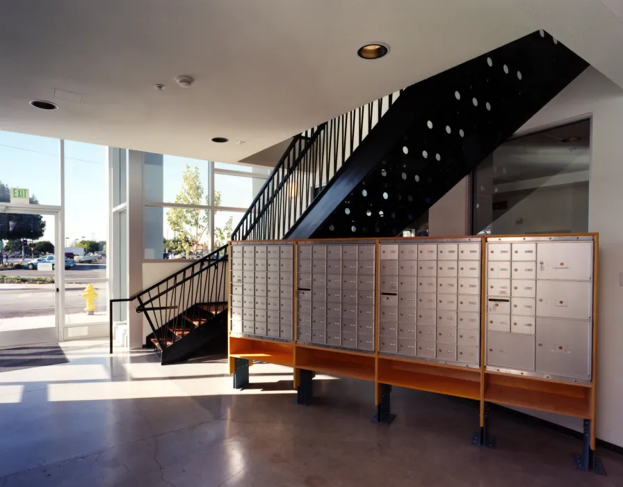 Entry lobby with mailboxes and stairs at Pensione Esperanza in San Jose, California. 