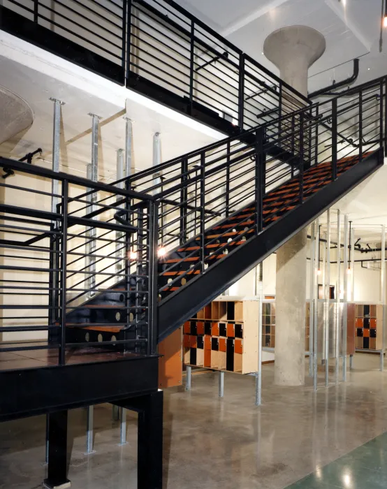 Lobby with stairs and mailboxes at  1500 Park Avenue Lofts in Emeryville, California.