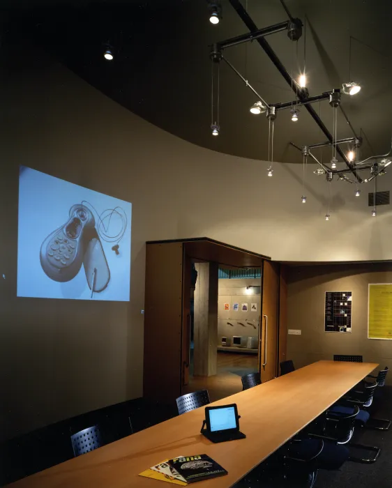 View of the conference room with a project and long conference room table at Frogdesign Studio in San Francisco. 