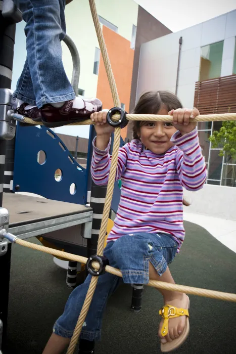 Child playing on the playground at Paseo Senter in San Jose, California.