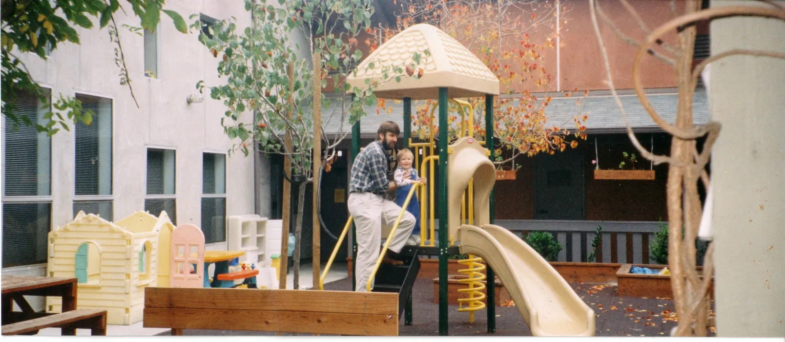 Man and child playing on the play structure at Sunrise Village in Fremont, California.