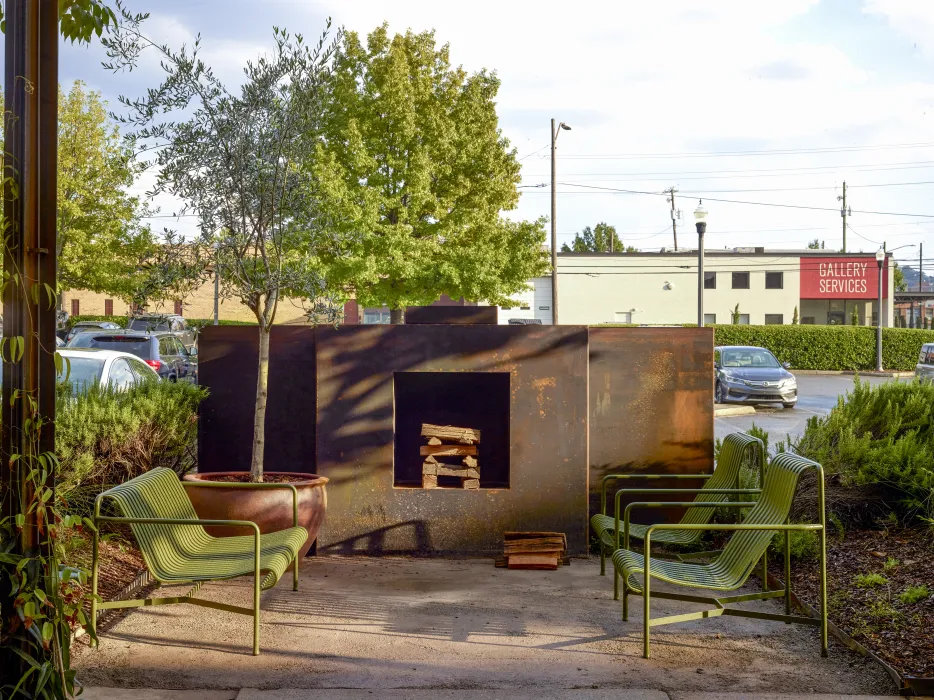 Outdoor steel fireplace and chairs at Bettola Restaurant in Birmingham, Alabama.
