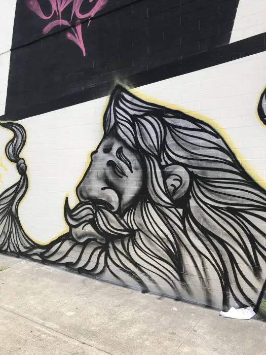 Detail of a piece of art of a man with a large beard on the side of David Baker Architects office in Oakland, California.