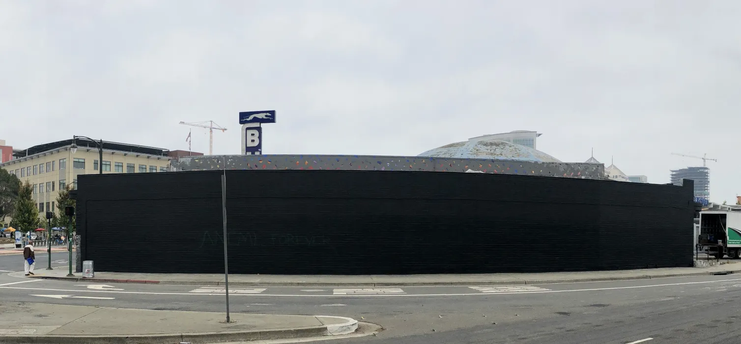 Exterior street view of the side of David Baker Architects Office painted black ready for street art in Oakland, California.