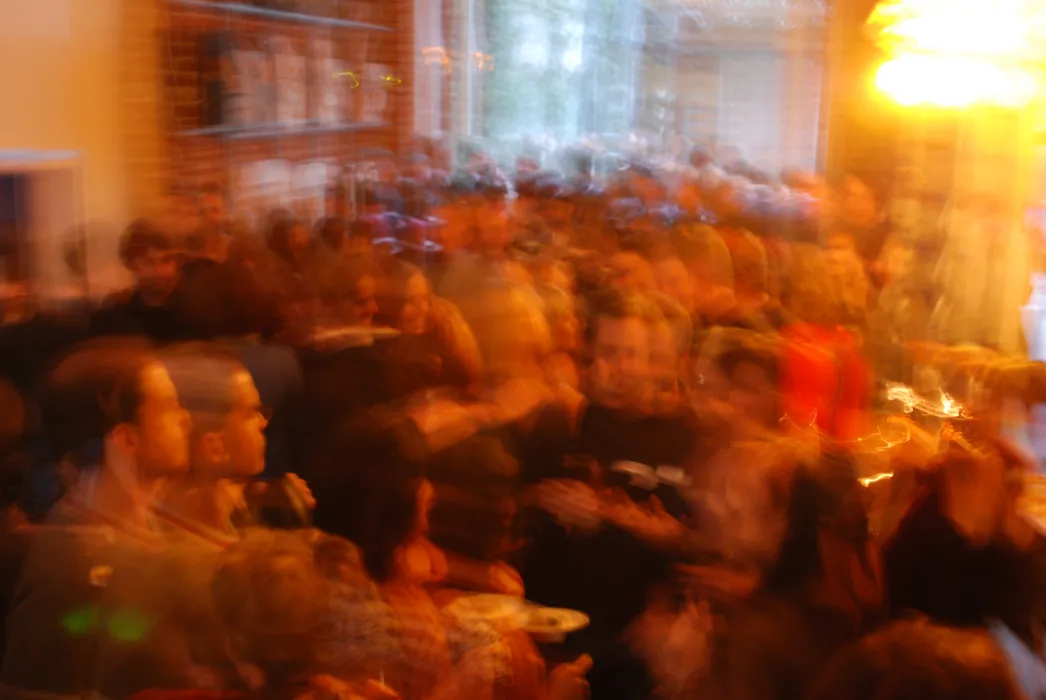 Blurry photo of a crowd during a party at David Baker Architects Office in San Francisco.
