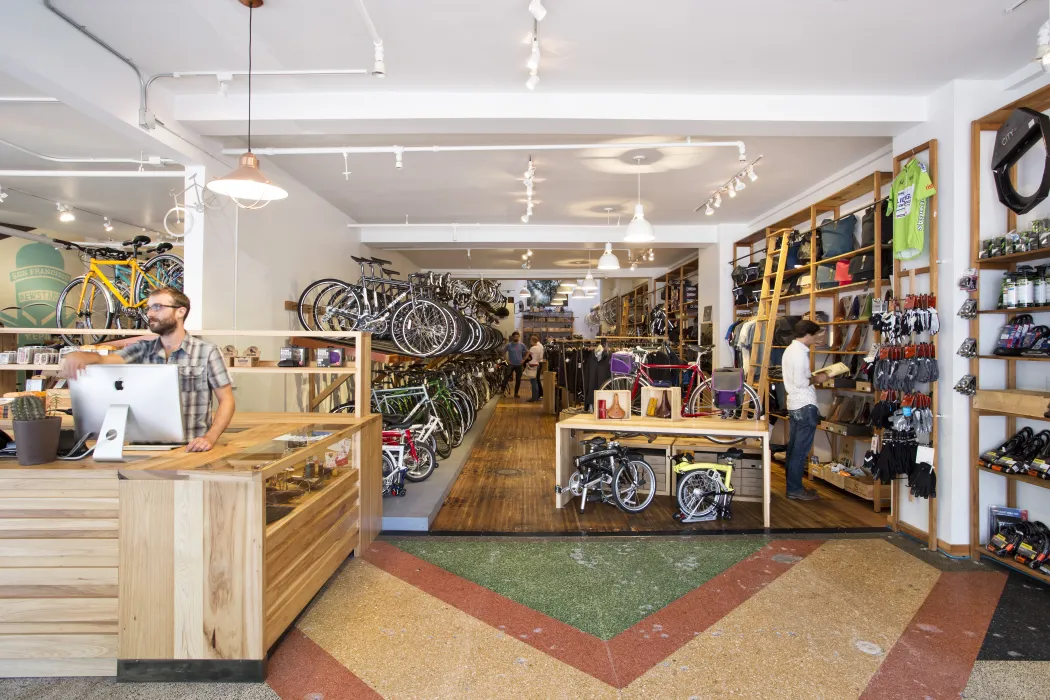Interior view of the counter and hanging bicycles inside Huckleberry Bicycles in San Francisco.