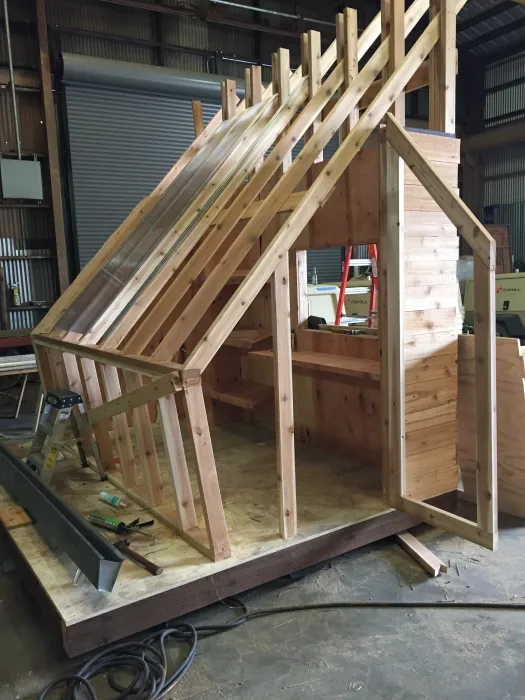 Progress shot of that Farm to Table a wooden farmstand-inspired mini-greenhouse playhouse.