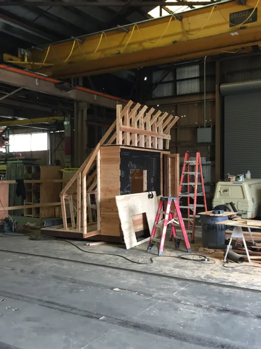 Progress building of Farm to Table a wooden farmstand-inspired mini-greenhouse playhouse