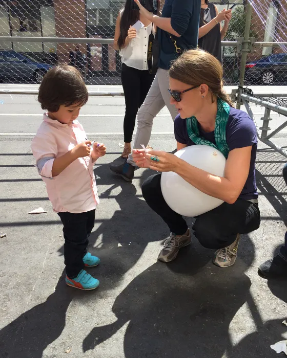 Woman and child looking at one of the balloons for Wishing Cloud