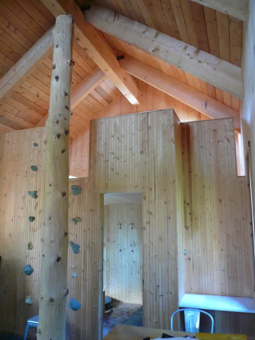 Interior view of Redstone Cabin with a rock climbing wall to get to the upstairs loft in Redstone Colorado.