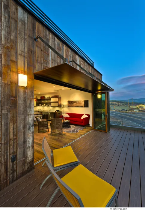 Looking into the living room from the balcony of Truckee Prototype Mixed-Use Townhouse in Truckee, California.