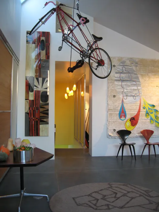 Living space with bikes hanging from the ceiling at Shotwell Design Lab in San Francisco.