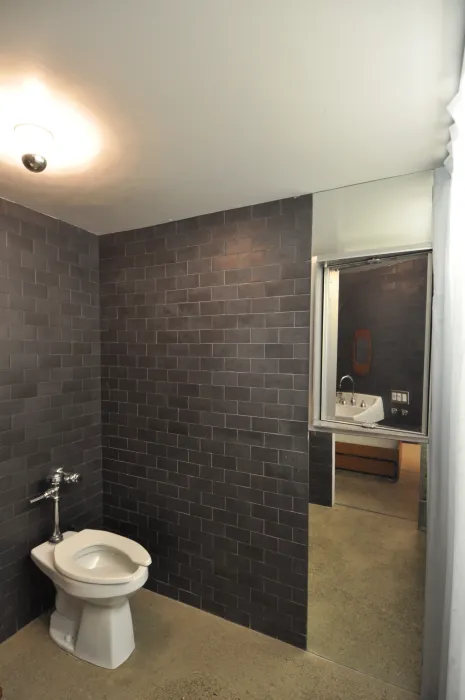 Bathroom covered in black tile inside Shotwell Garden Retreat in San Francisco.