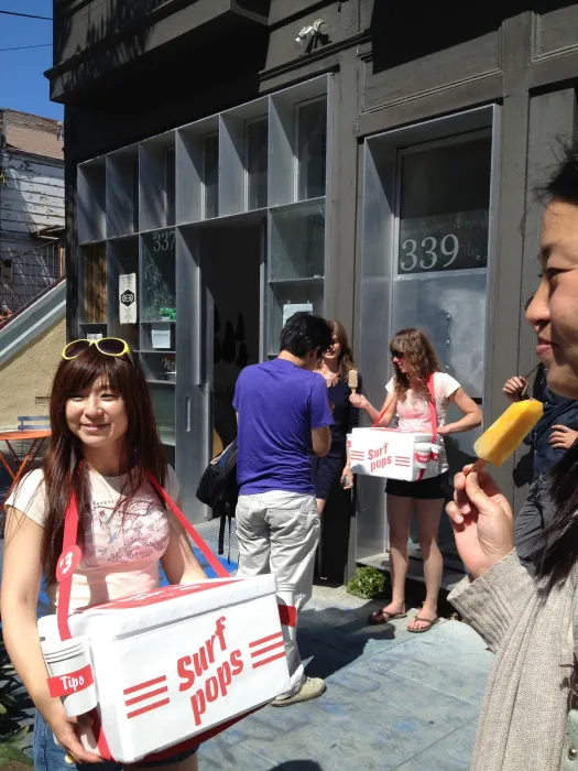 People standing outside StoreFrontLab selling popsicle art.