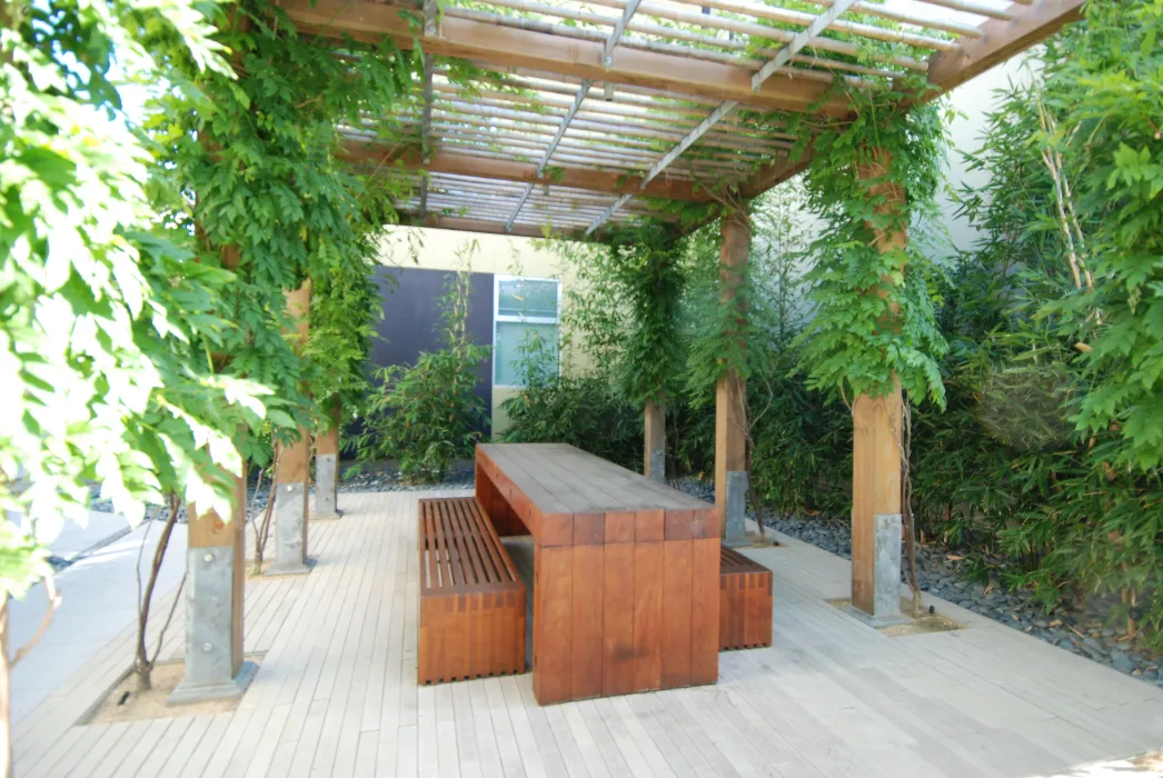 Outdoor table surrounded my greenery at West End Commons in Oakland, Ca.