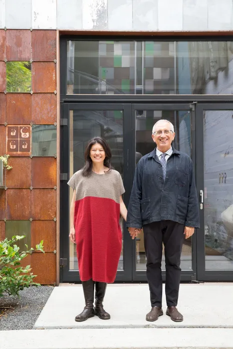 A woman and a man holding hands in front of Zero Cottage in San Francisco.