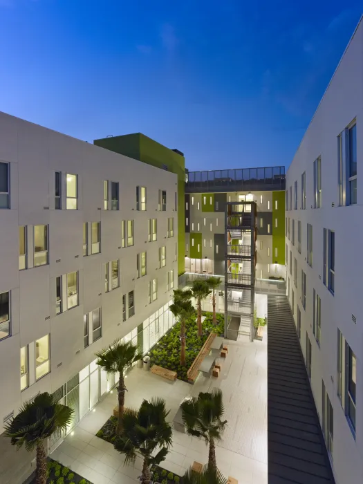 Night view of illuminated courtyard at Richardson Apartments in San Francisco.