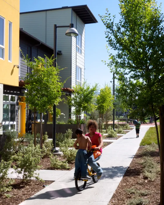 Kids riding a bike at Tassafaronga Village in East Oakland, CA. 