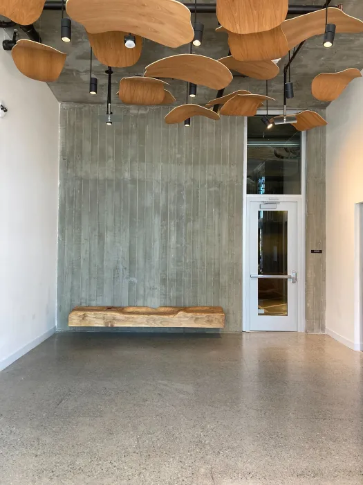 Custom sculpture and bench by DBA Workshop inside Coliseum Place, affordable housing in Oakland, Ca