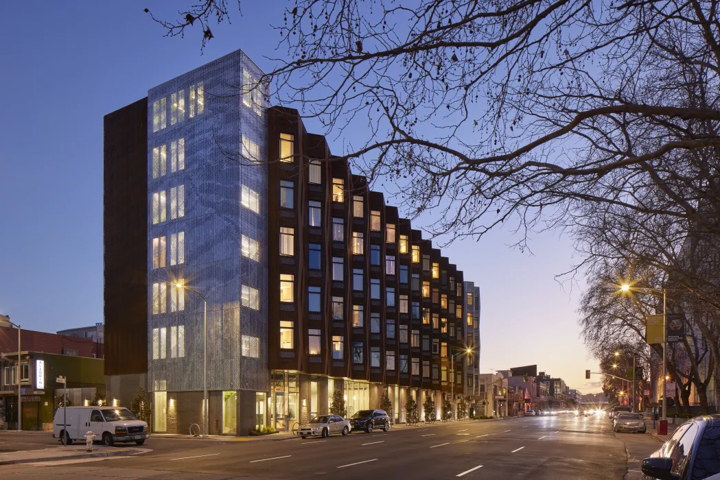 Exterior view at dusk of Tahanan Supportive Housing in San Francisco.