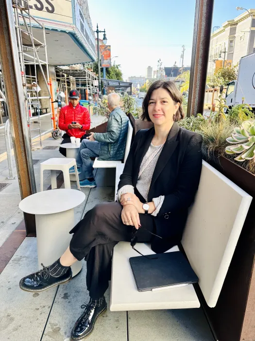 DBA Principal, Amanda Loper sitting at the Saint Frank Parklet in San Francisco.