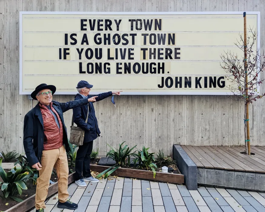 Refurbished sign at the previous site, now sits in the courtyard at 555 Larkin in San Francisco which states "Every town is a ghost town if you live there long enough. - John King"