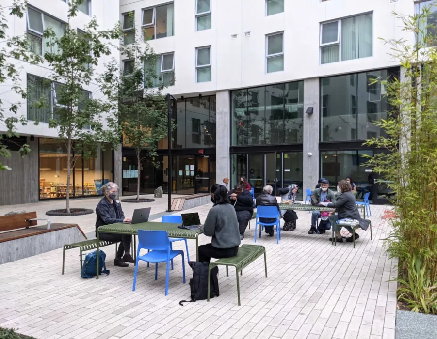 DBA staff talking with residents at 222 Taylor in San Francisco.