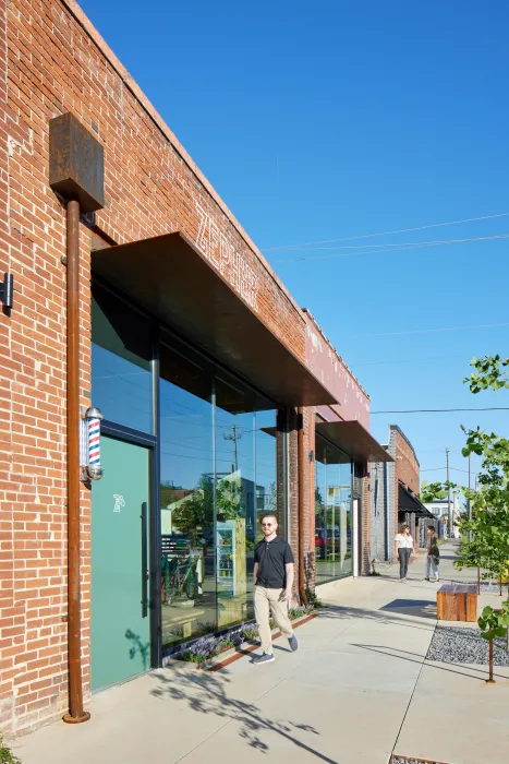 Exterior view of the barbershop and bakery from the sidewalk at the Bandsaw Building in Birmingham, Alabama.