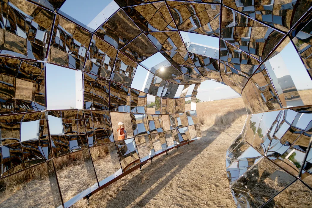 Looking through peepSHOW in the desert with mountains behind it in New Cuyama, California.