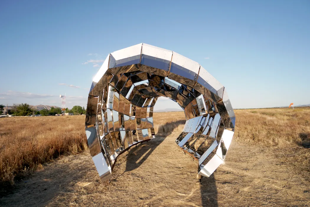 Looking through peepSHOW in the desert with mountains behind it in New Cuyama, California.